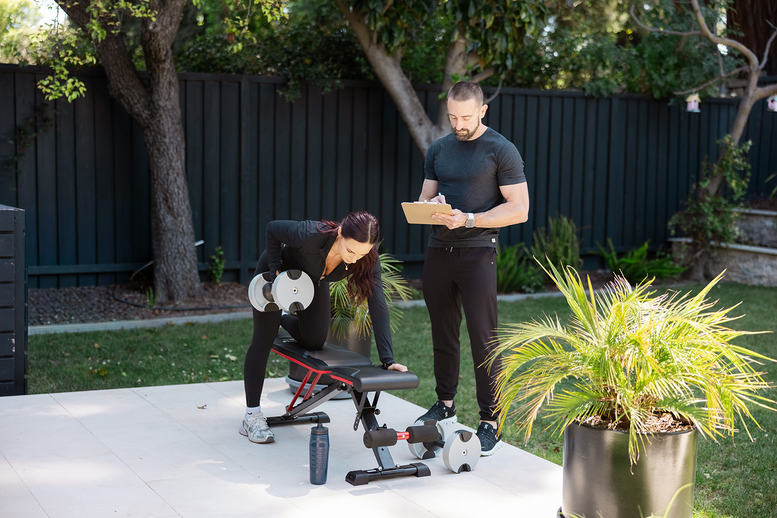 Mick coaching a client through a dumbbell exercise